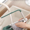A hand is using an adjustable over-sink dish rack organizer to clean a sink, demonstrating smooth inner corners.