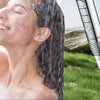 A woman is showering, and a filtered high-pressure shower head is visible on the right side of the image.