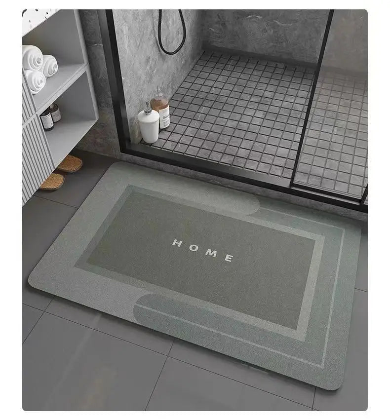 A rectangular gray anti-slip floor mat is placed on a dark tile floor in a modern bathroom setting.