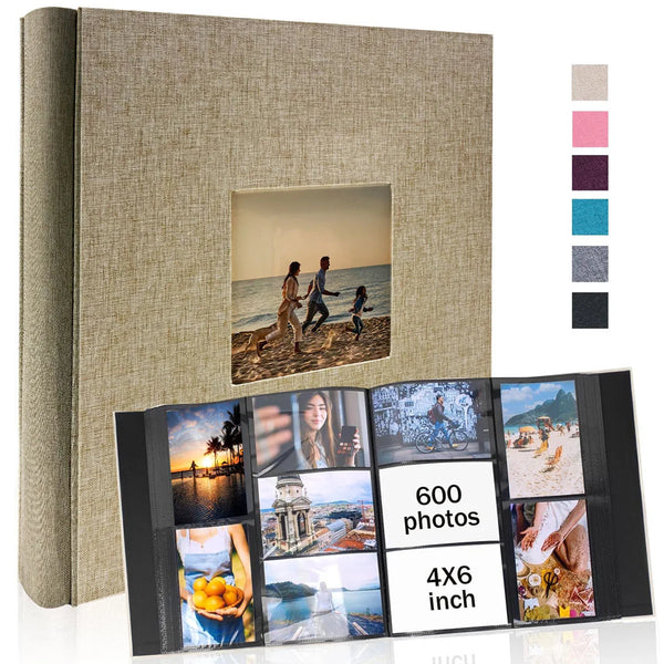 A linen photo album with a cover displaying a landscape, showing several photo pages.