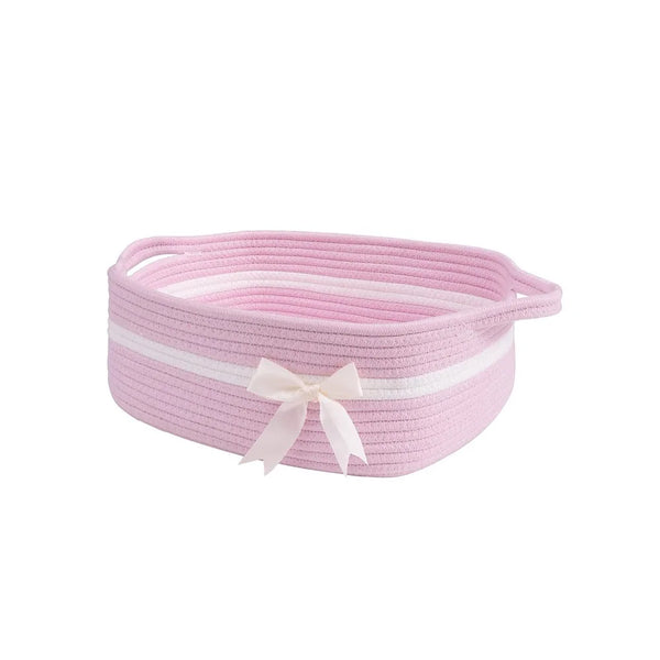 Pink woven cotton rope storage basket with a white ribbon bow