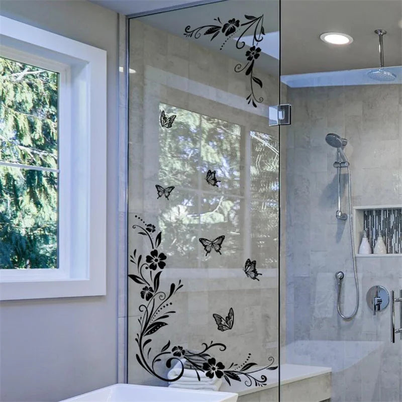 Decorative flower butterfly wall stickers on a glass shower door in a modern bathroom
