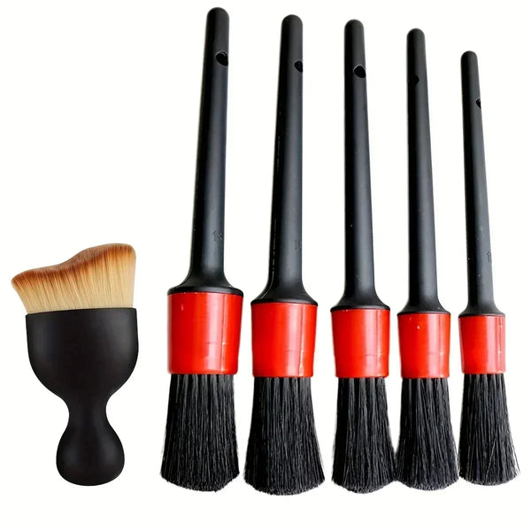 A set of black detailing brushes used for cleaning wheels and interiors.