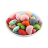 A pile of ten colorful hot heart silicone charm beads in various shades of pink, green, yellow, and orange.