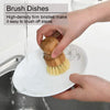 Hands are brushing dishes with bamboo dish scrub brushes featuring sisal bristles.