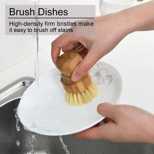 Hands are brushing dishes with bamboo dish scrub brushes featuring sisal bristles.