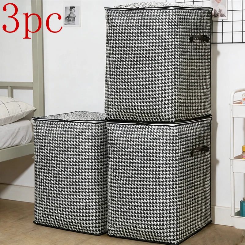 Three black and white checkered foldable clothing storage bags standing vertically.