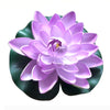 A vibrant purple artificial lotus flower with green leaves used for pond and garden decor.