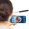 A person is using a visual ear cleaning tool with an LED camera to examine the ear.