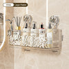 A clear stainless steel suction cup storage rack holding various beauty products like perfume bottles and brushes.