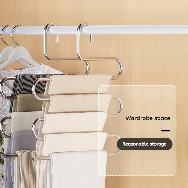 A multi-layer stainless steel clothes rack displaying various folded towels and fabric items.