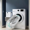 A white washing machine is shown with a reusable shoe washing bag placed on top of it.