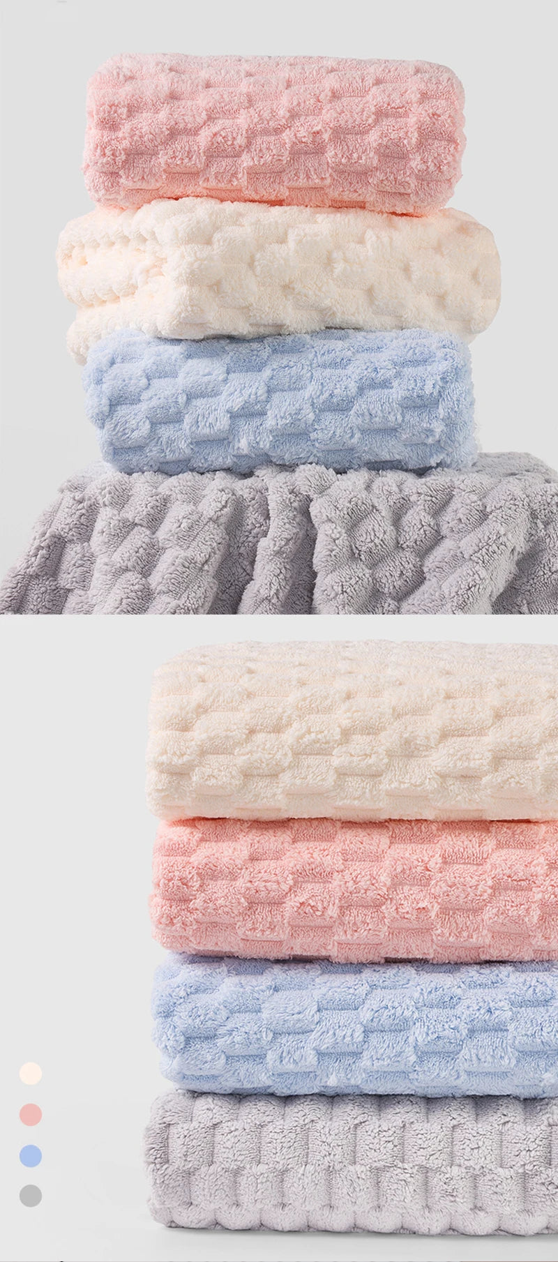 A stack of four thickened microfiber bath towels in pastel colors: pink, cream, light blue, and gray.