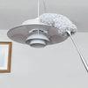 A white flexible microfiber cleaning duster brush with a fluffy gray head is suspended from the ceiling.