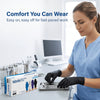 A woman wearing blue scrubs puts on disposable nitrile gloves for work.
