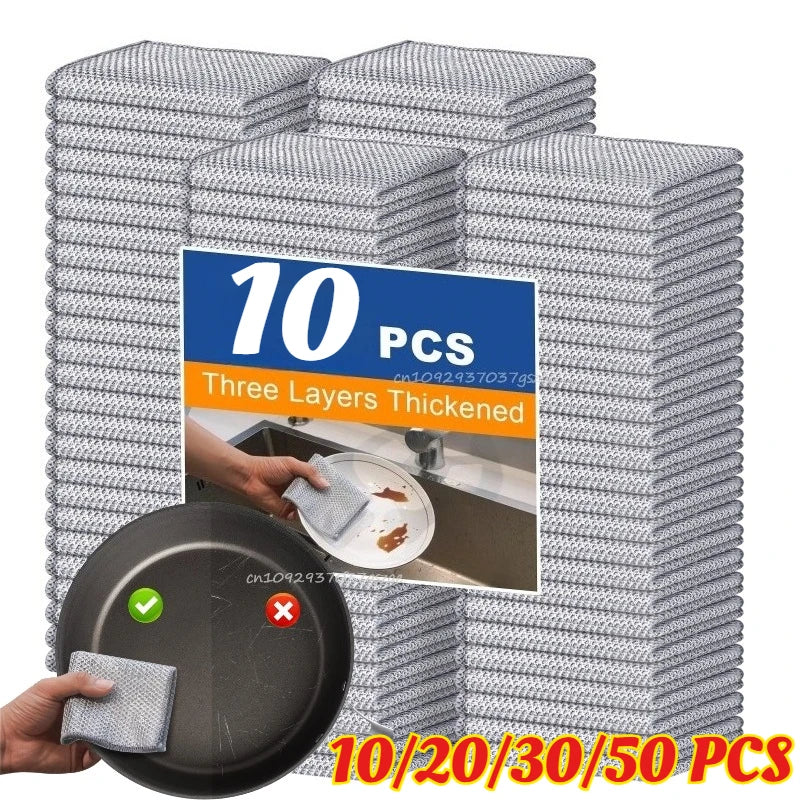 A stack of silver microfiber dishcloths is shown with a single cloth being used on a black plate.