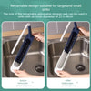 A white and blue retractable dish rack organizer is shown being used in a stainless steel kitchen sink.