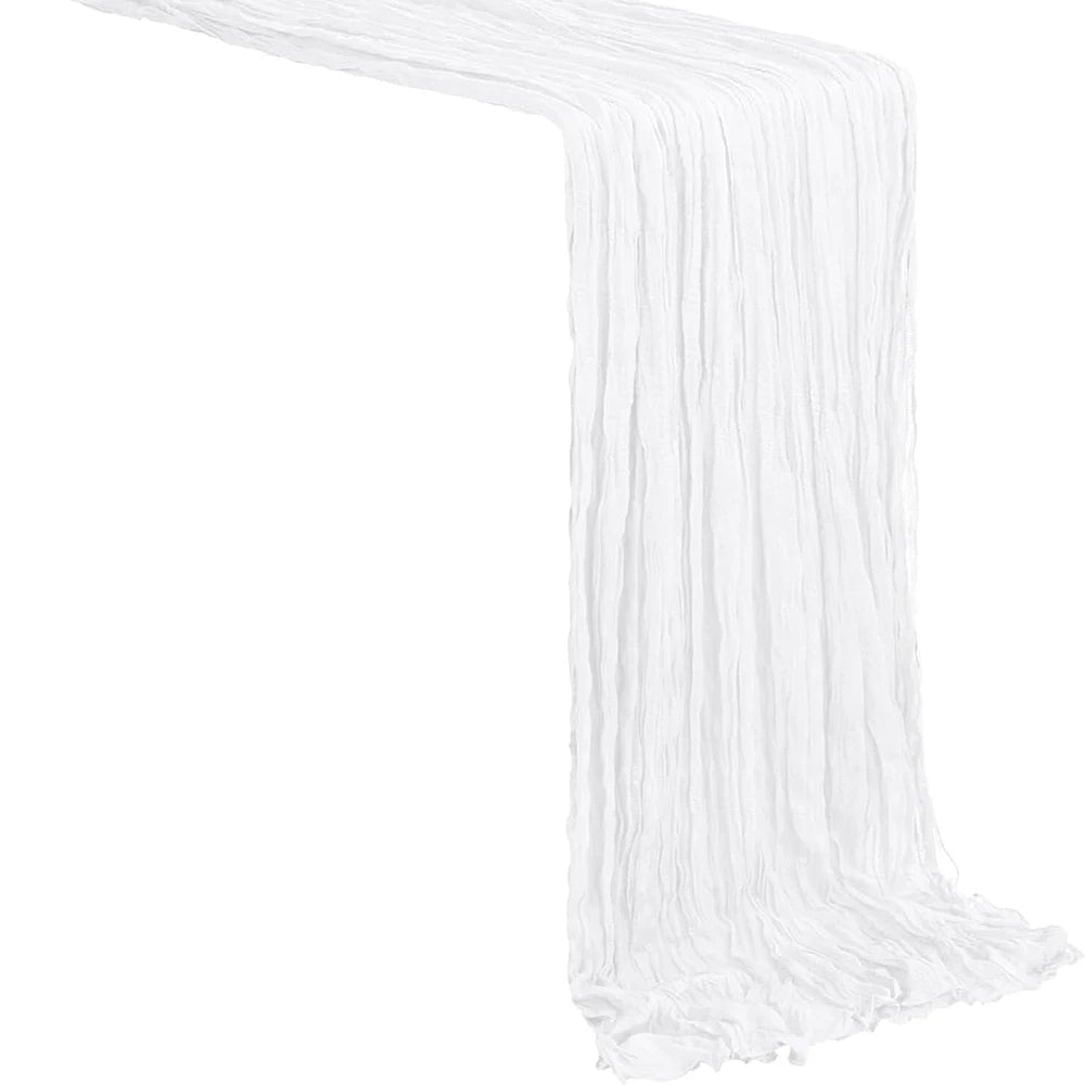 White boho sheer fabric table runner draped in a vertical pleat