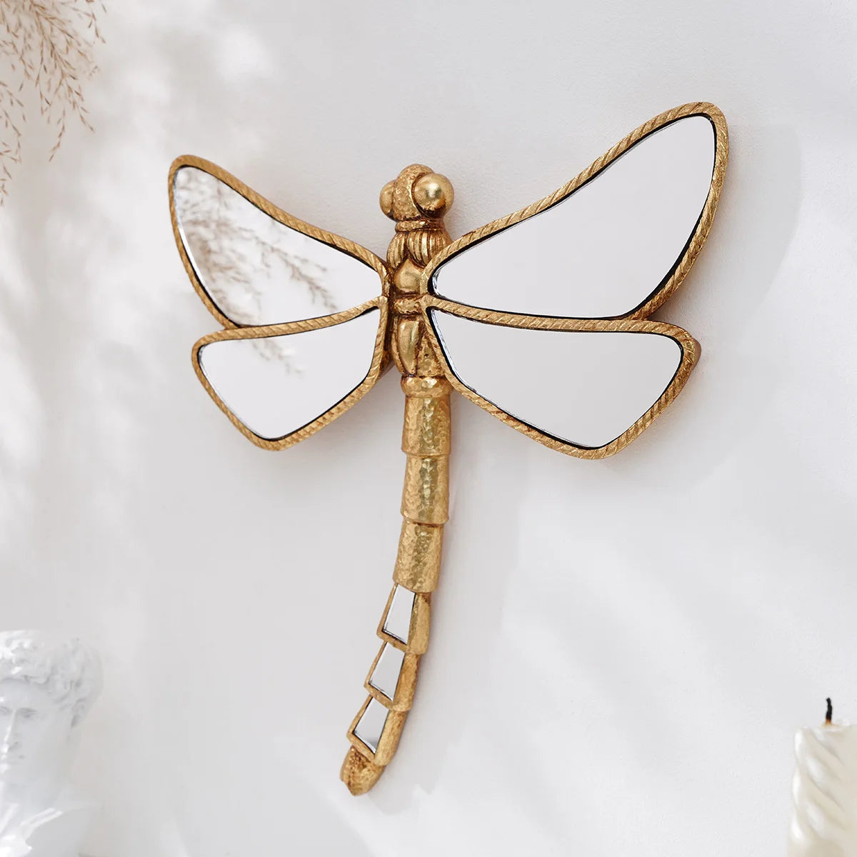 Golden dragonfly mirror wall decor featuring a detailed, gilded insect design.
