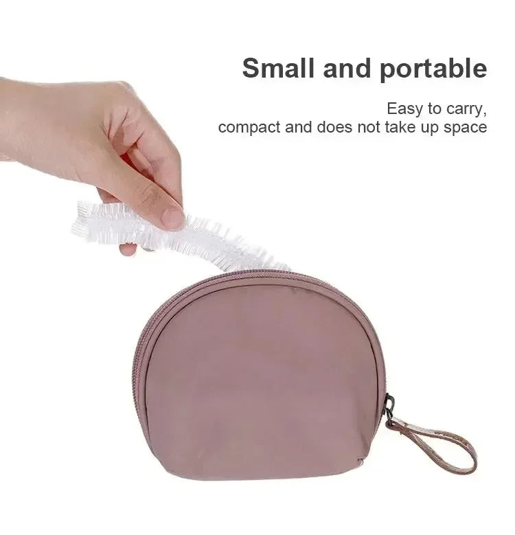 A hand is holding a small, pink reusable disposable shower cap for hair protection.