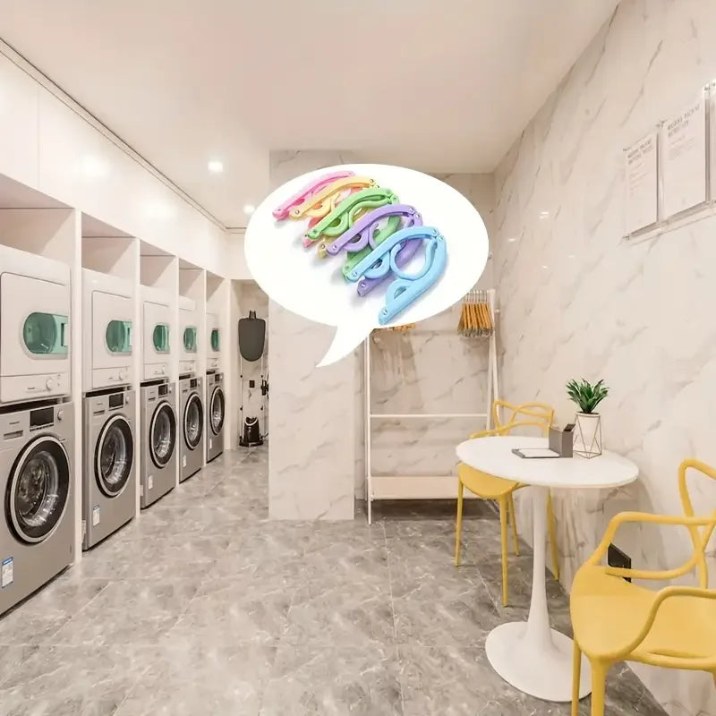 A collection of colorful portable foldable clothes hangers displayed in a bright laundry room setting.