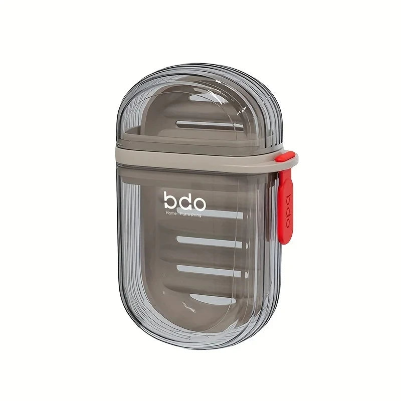 A clear, leakproof portable soap dish with a gray lid and red handle for travel or kitchen use.