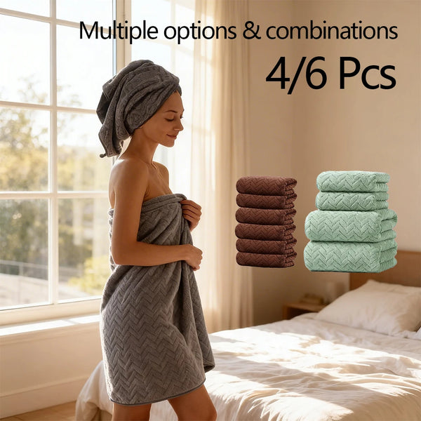 A woman wearing a gray towel stands next to a window with stacks of folded green and brown towels.