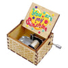 A mini wooden music box with a hand-crank mechanism and a lid featuring the text You are my sunshine.