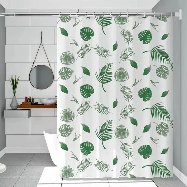 A white shower curtain featuring a pattern of green tropical leaves and palm fronds.