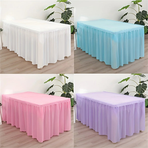 A set of disposable rectangular tablecloths in white, light blue, pink, and purple fabric displayed on a wooden floor.