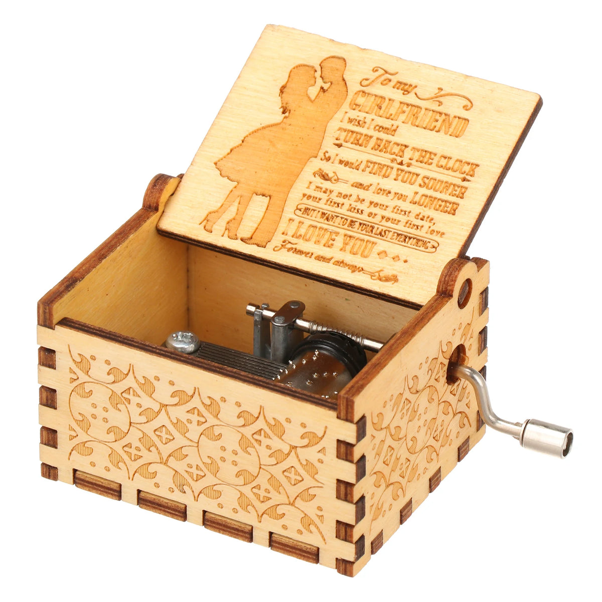 A vintage engraved wooden music box with a lid open showing an engraved message and a small metal mechanism.