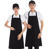 Two models wearing classic black chef aprons with large front pockets