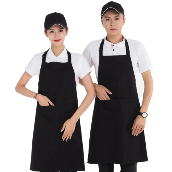 Two models wearing classic black chef aprons with large front pockets