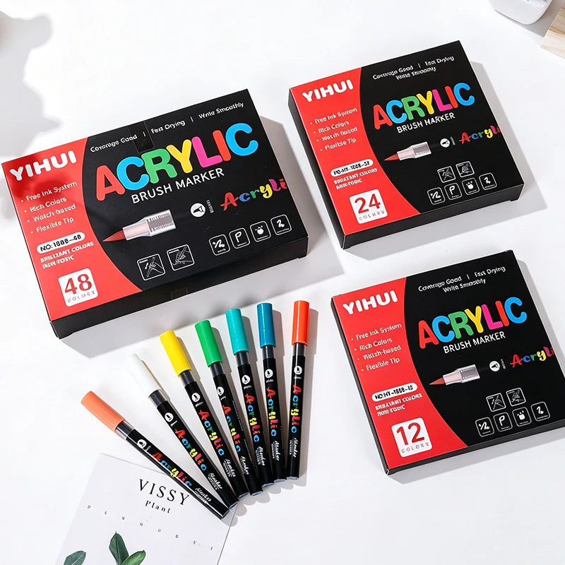 A set of Yihui acrylic brush markers in various colors and tips displayed on a white surface.