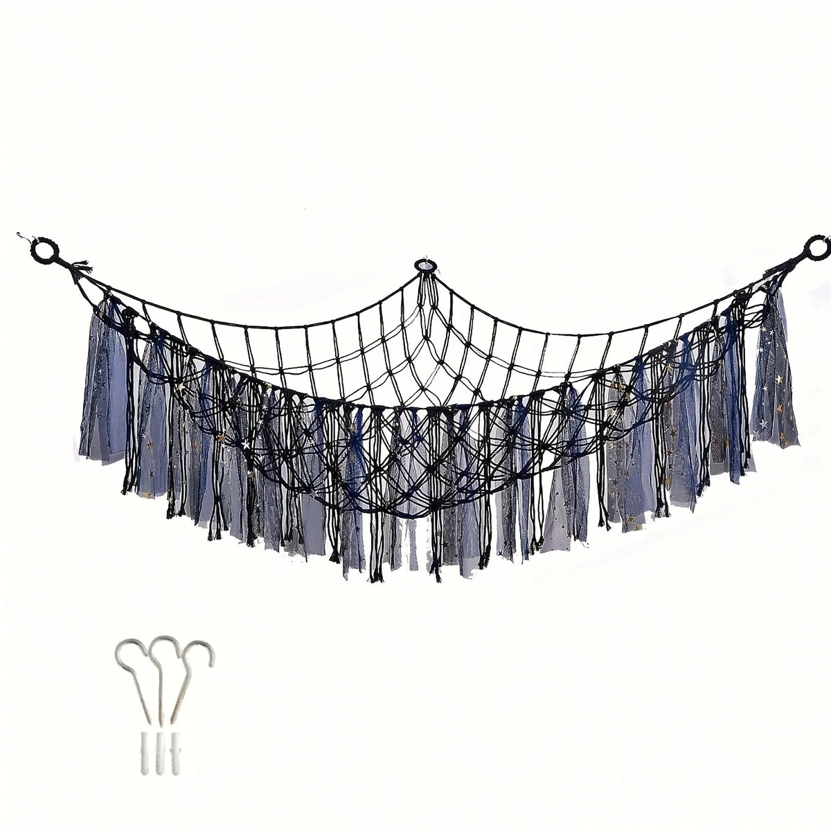 A bohemian stuffed animal hammock made of dark blue and gray fabric with fringe details.