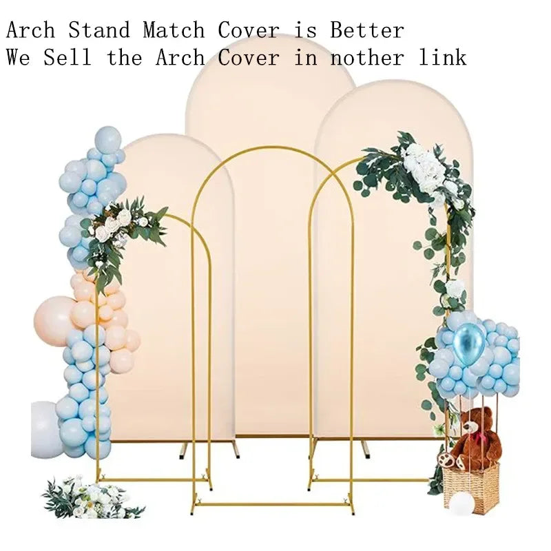 A set of adjustable gold arch stands in a pale pink color for party decor.