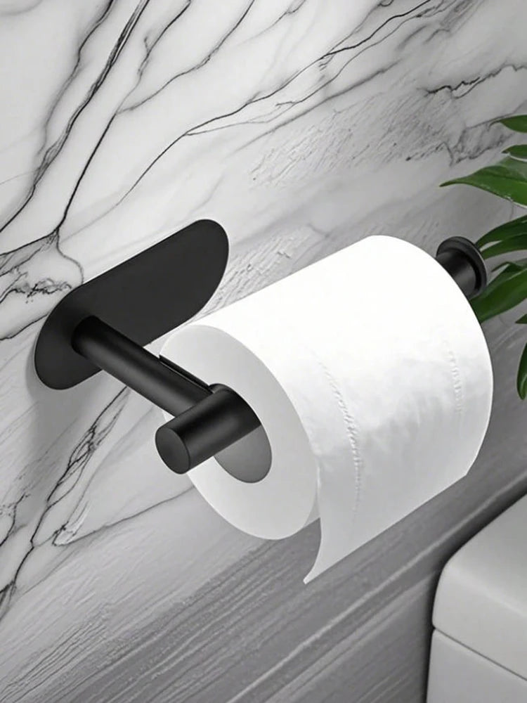 A black stainless steel self-adhesive toilet paper holder mounted on a marble wall.