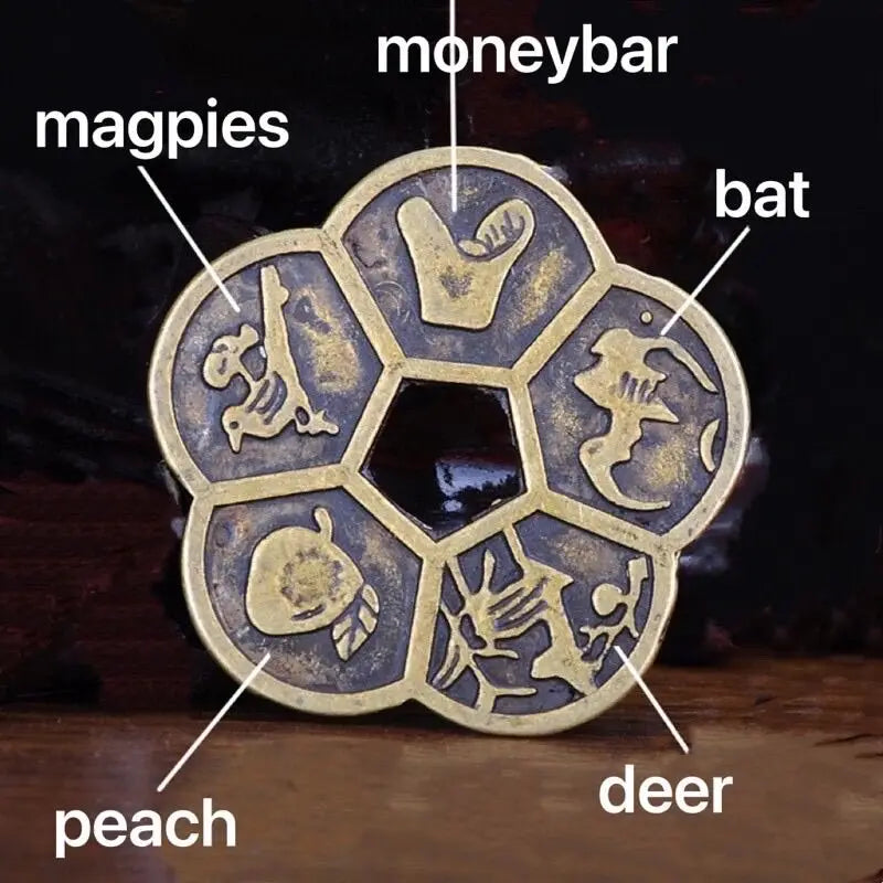 A set of traditional copper Feng Shui coins featuring animals like magpies, bat, peach, deer, and monkey.