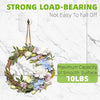 A wreath of flowers and greenery hanging from a strong load-bearing wall hook.