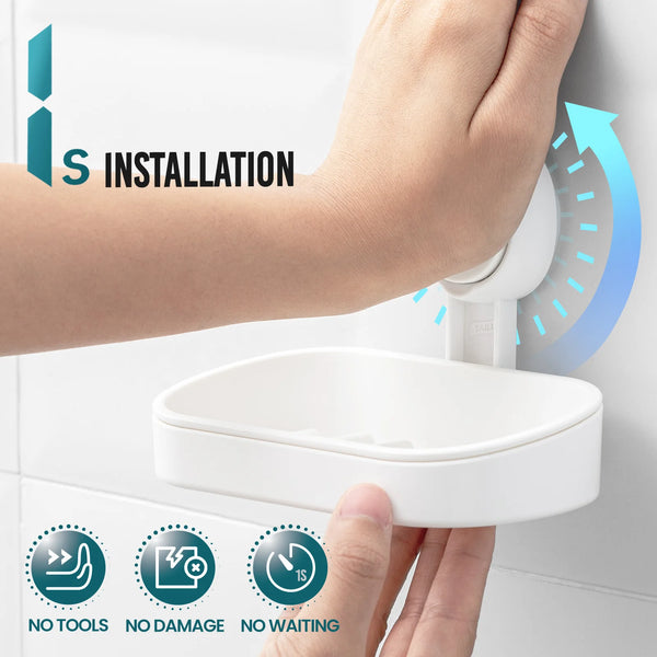 A hand installs a white silicone soap dish holder onto a white wall, demonstrating drill-free installation.