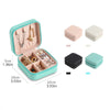 A teal portable PU leather jewelry storage box shown open with various necklaces and earrings displayed inside.