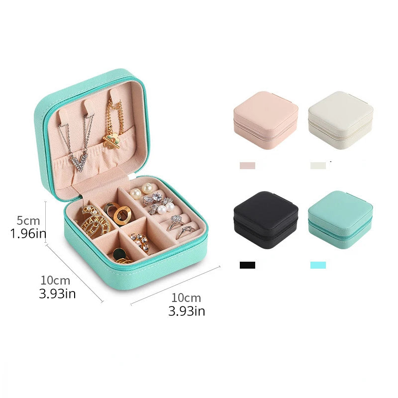 A teal portable PU leather jewelry storage box shown open with various necklaces and earrings displayed inside.