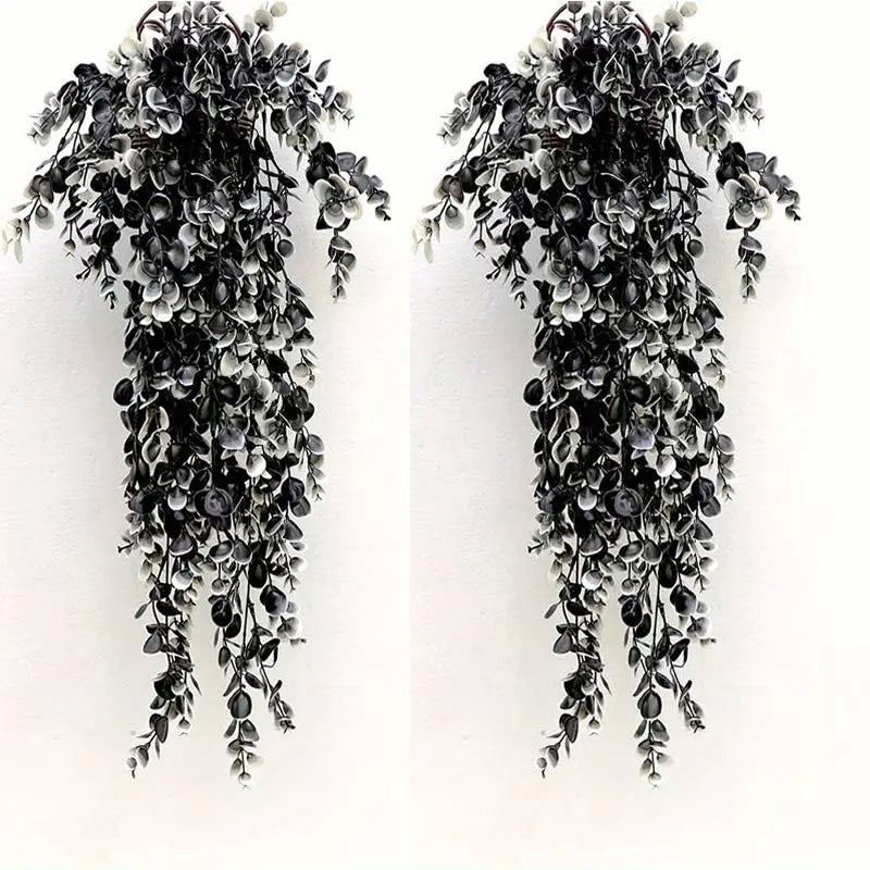 A vertical arrangement of artificial black and white foliage garland for home decor