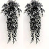 A vertical arrangement of artificial black and white foliage garland for home decor