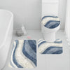 A set of three soft blue and white striped non-slip bathroom rugs, including a toilet mat.