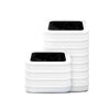 A stack of white reusable refill rings designed for kitchen trash cans.