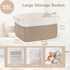 Large storage basket made of woven cotton in beige and cream colors shown next to various items like blankets, pillows, and t