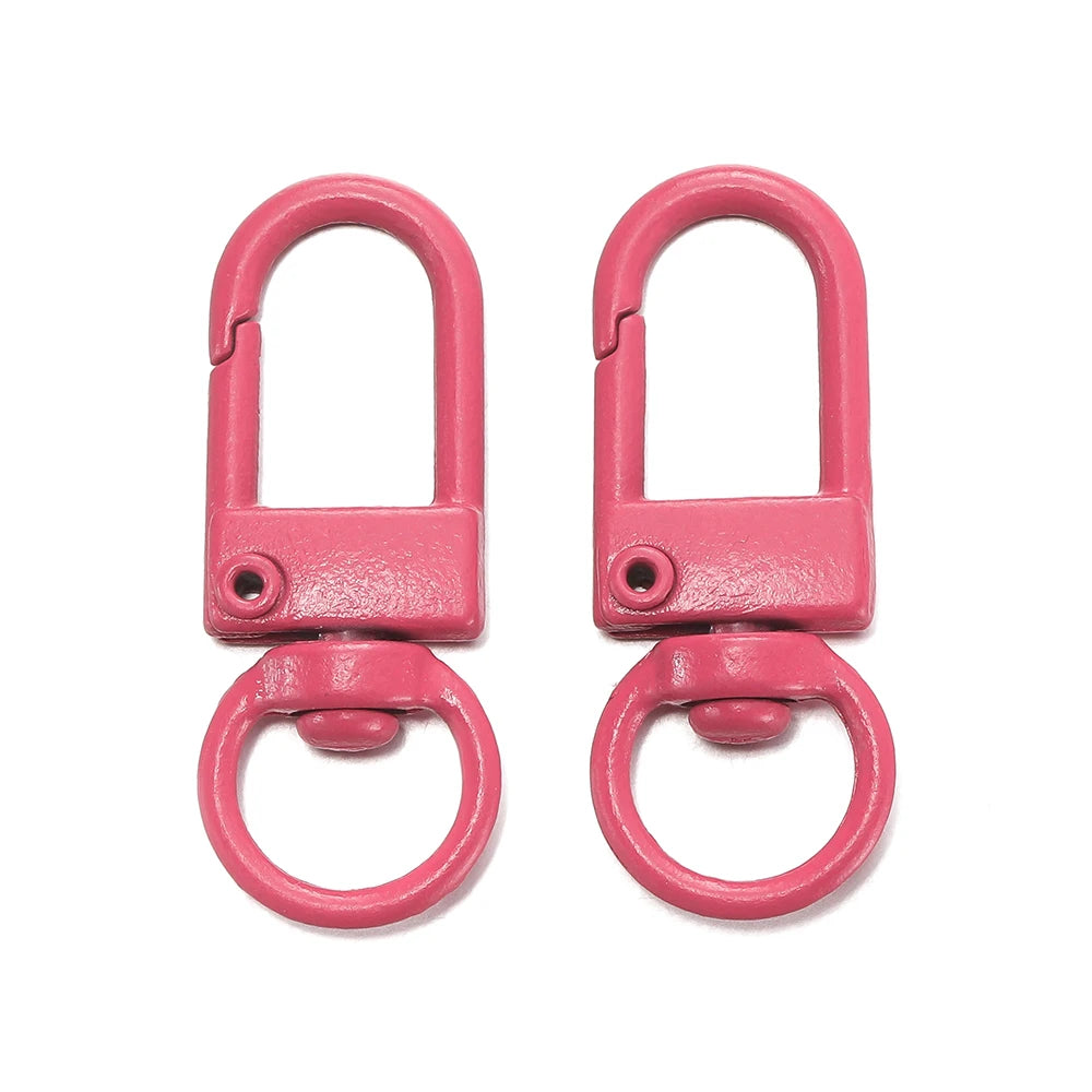A pair of pink alloy snap lobster clasp hooks for jewelry making