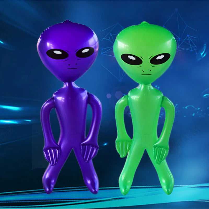 Two inflatable alien decorations, one purple and one green, standing side by side.