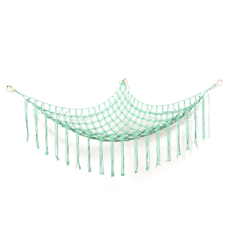 A turquoise plush animal hammock storage net with dangling strands.